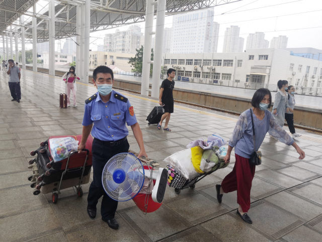 列车员|老人拉着大包行李独自乘车 列车员一路护送到家