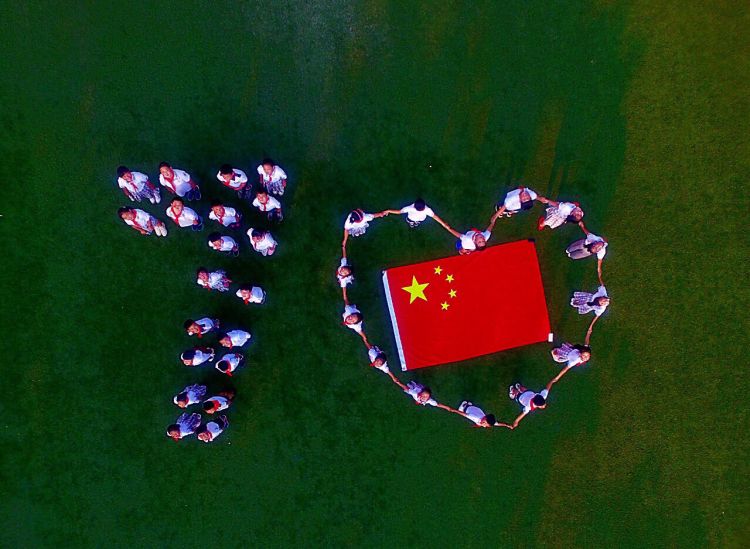队员们围绕国旗摆成各种形状,用简单,质朴的行动为新中国成立70周年