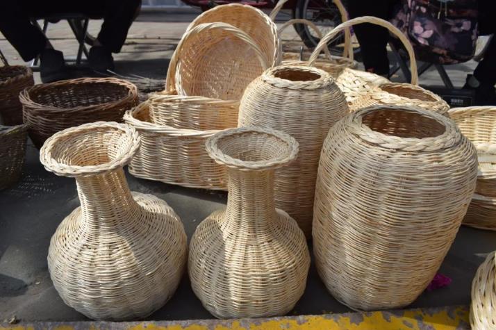 "你看这些白色的,都是用柳条编的,那些颜色较深的是用榆树条编的.